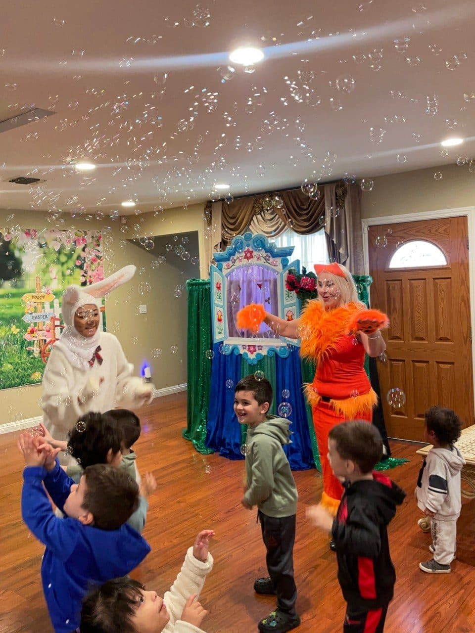Bunny and fox characters delight children amid a flurry of bubbles.