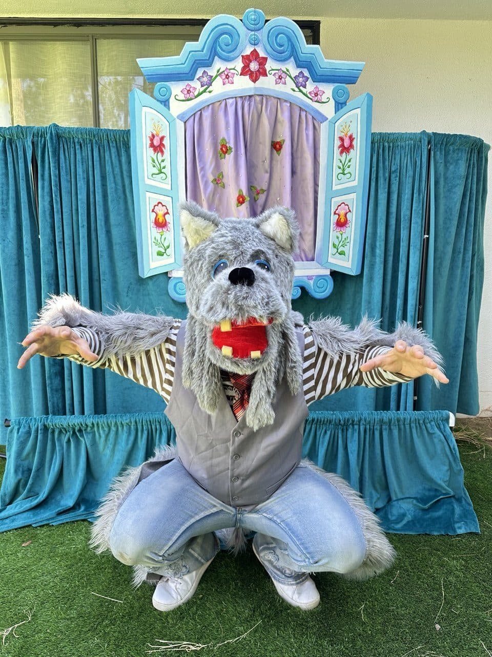 A performer in a furry wolf costume strikes a playful pose.